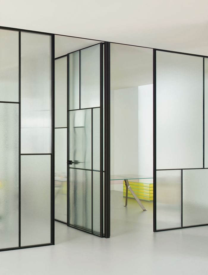The Glas Italia Sherazade Wall Patchwork is a floor-to-ceiling partition wall made by juxtaposing and fixing panels divided into four squares through a click system, featuring different types of monolithic tempered glass.