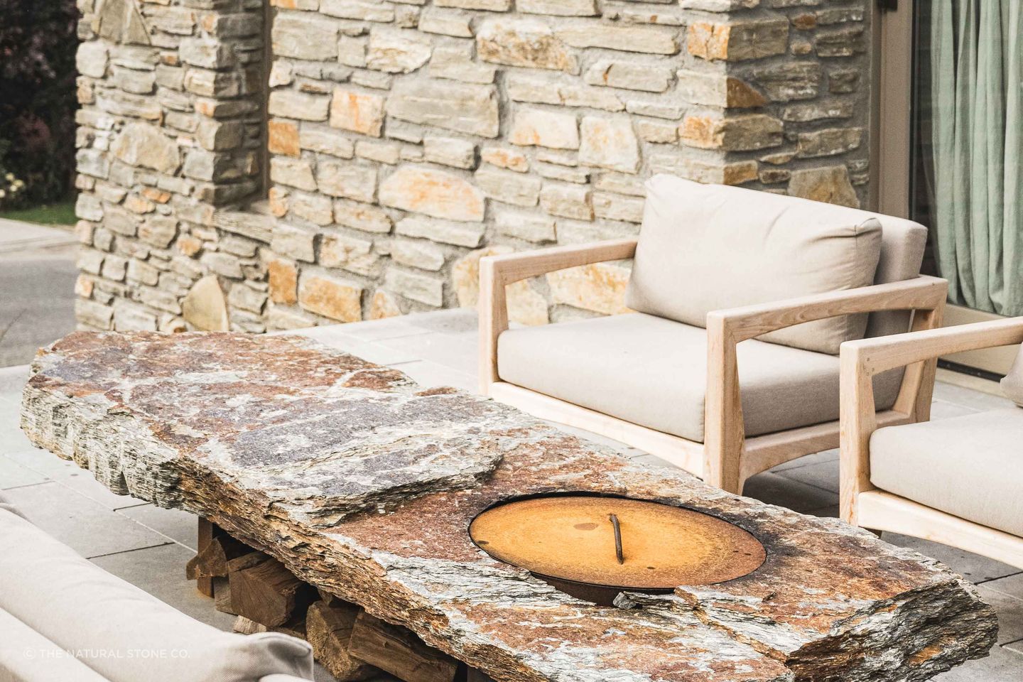 A bespoke schist firepit by The Natural Stone Co..