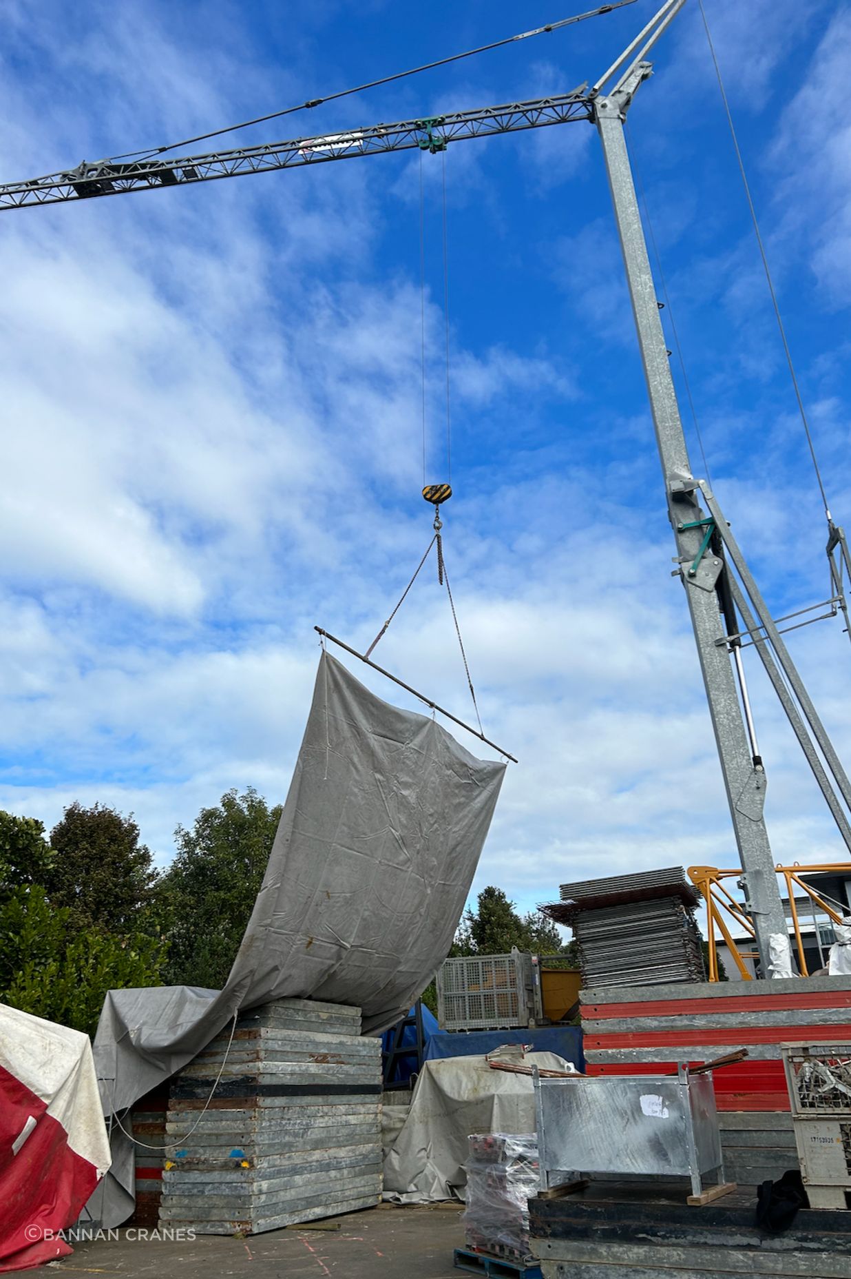 The crane can cover site areas with tarps to keep an area or material dry.