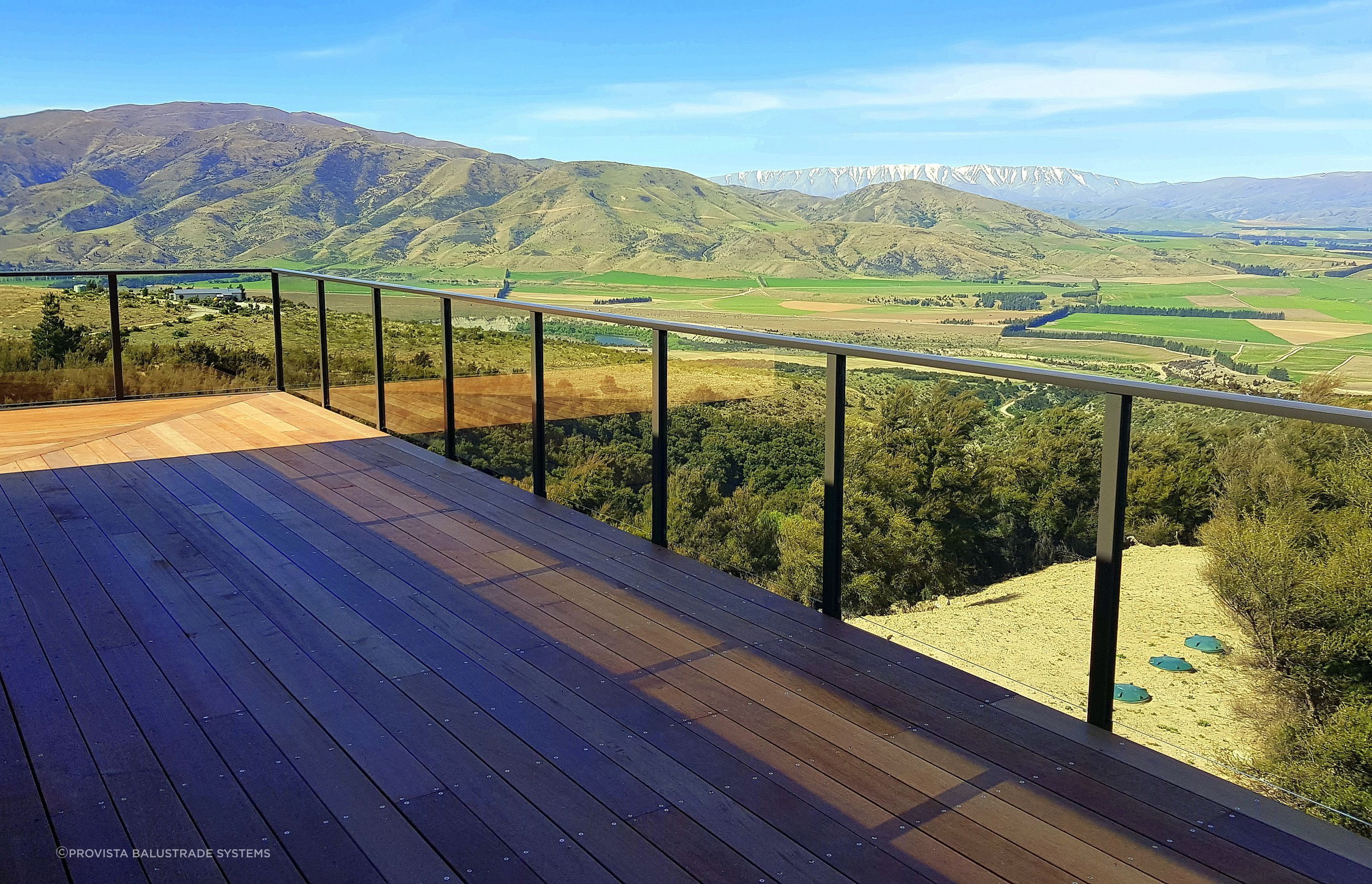 A semi frameless glass balustrade by Provista Balustrade Systems gives a clean and modern look, opening this deck up to the views.