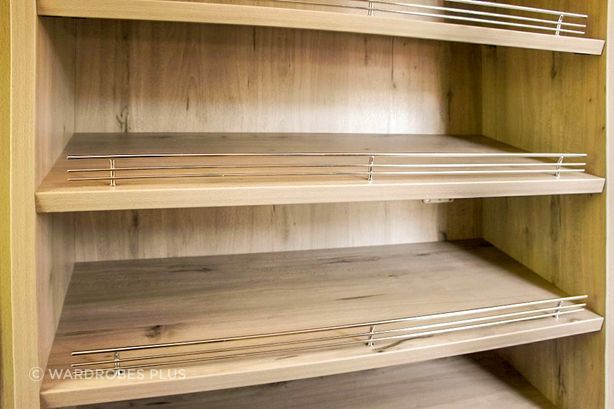 Open shelving with shoe fences.