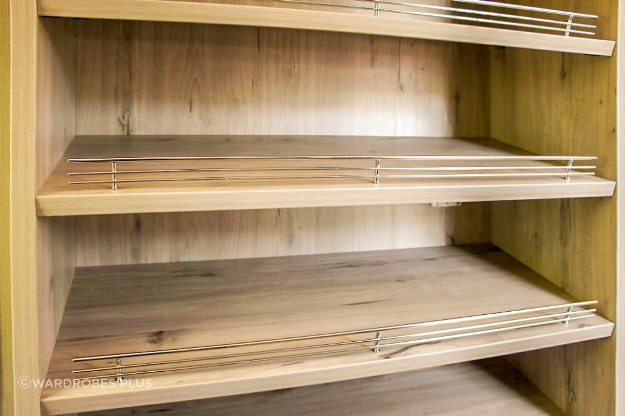 Open shelving with shoe fences.