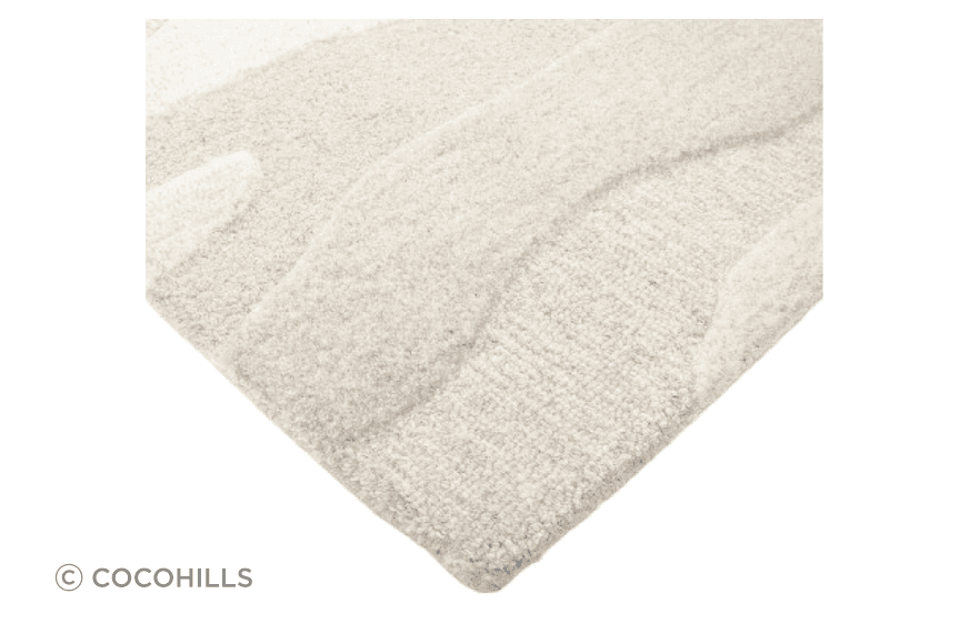Handtufted from 100% wool, the undulating design of the Shoreline rug is achieved through sections of cut and looped pile, resulting in a captivating visual piece.