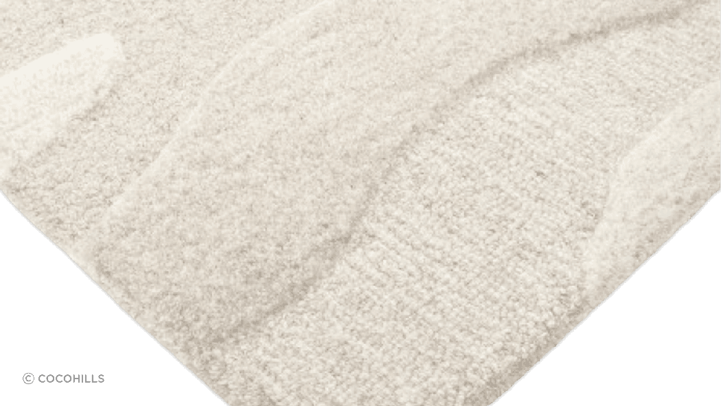 Handtufted from 100% wool, the undulating design of the Shoreline rug is achieved through sections of cut and looped pile, resulting in a captivating visual piece.