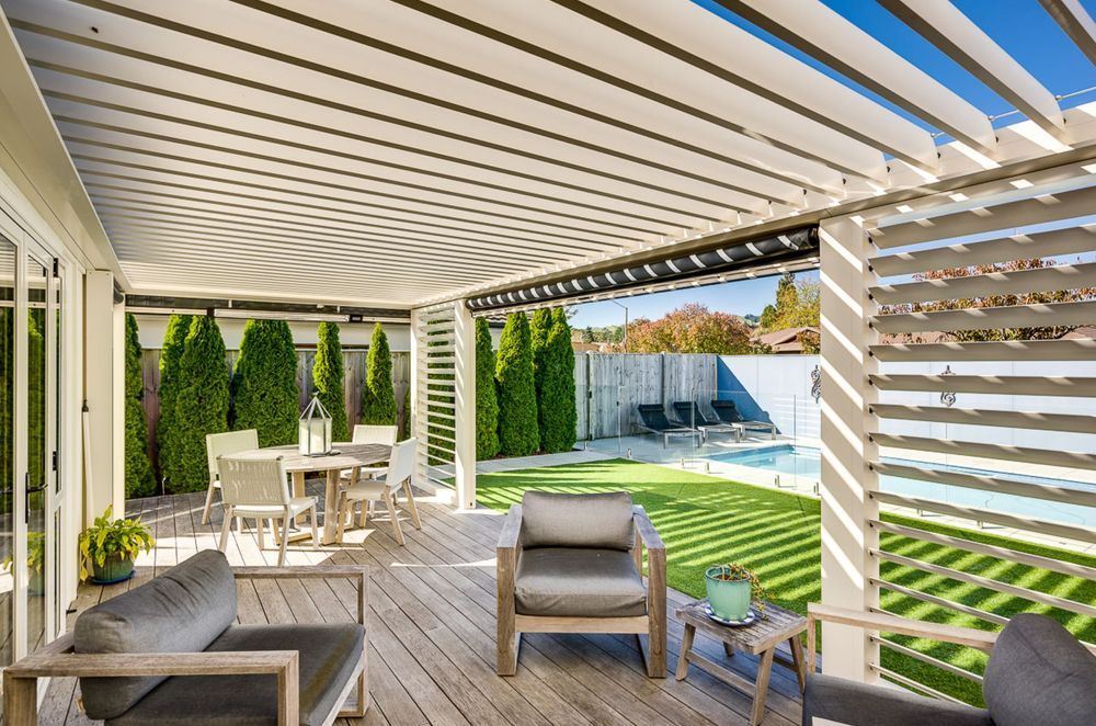In this Hawke's Bay property, a louvre system uses vertical and horizontal louvres along with blinds to create a complete outdoor room.