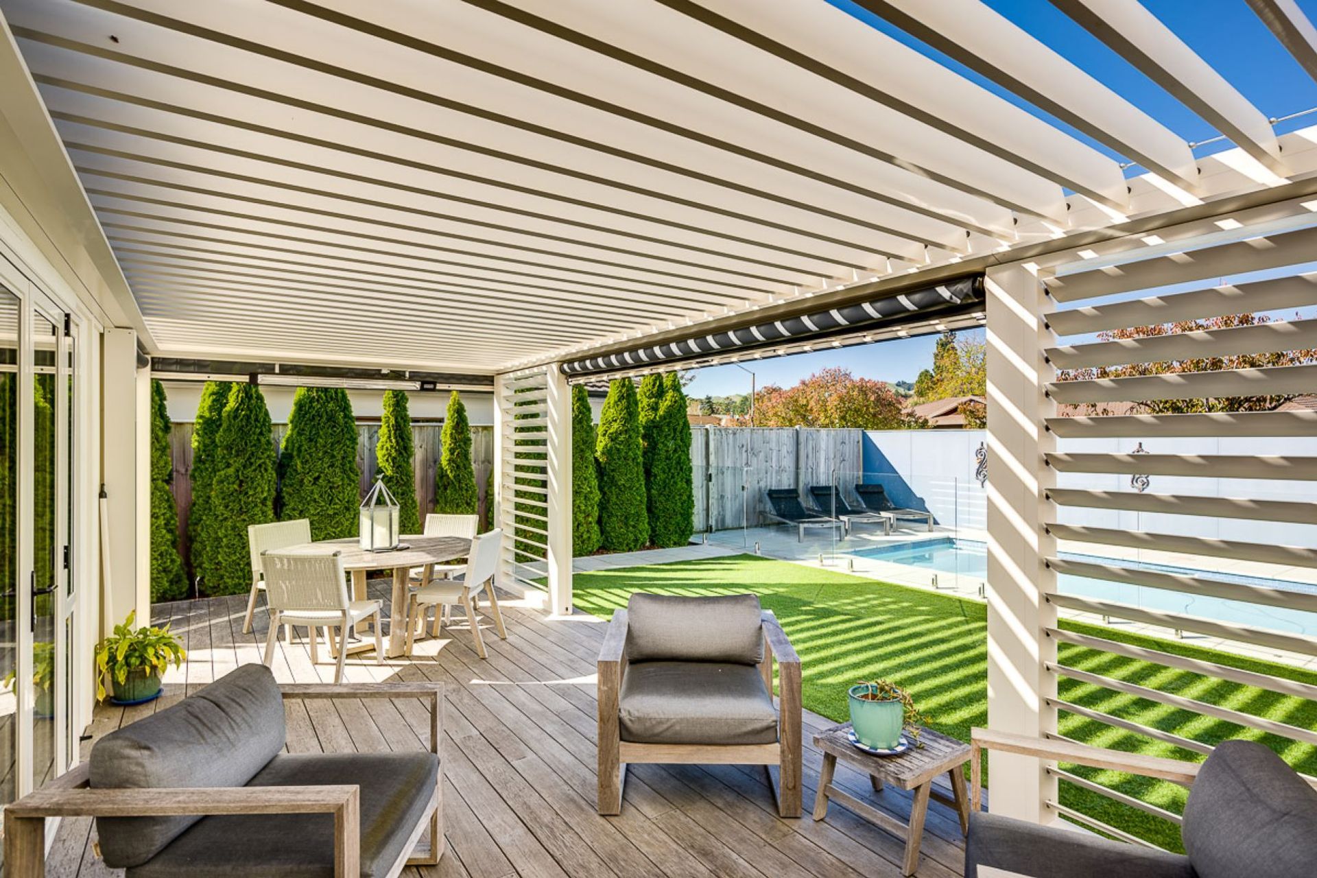 In this Hawke's Bay property, a louvre system uses vertical and horizontal louvres along with blinds to create a complete outdoor room.