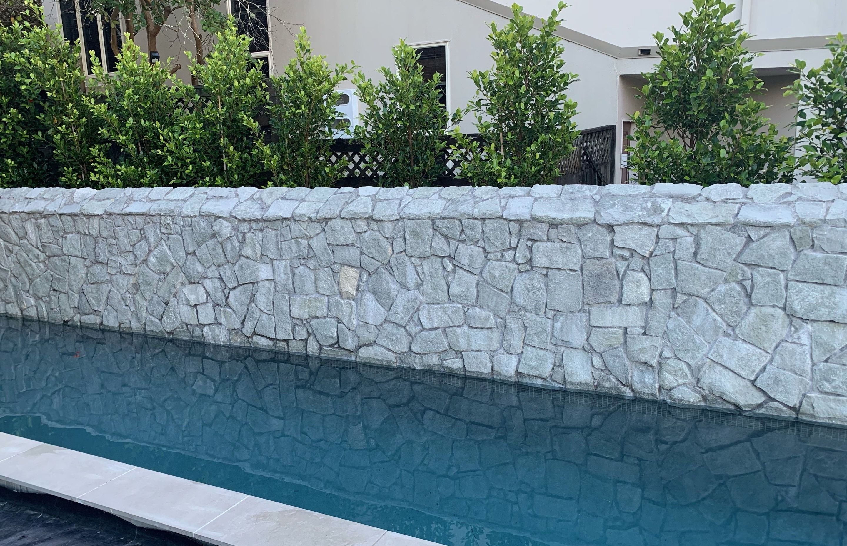 A grey limestone exterior wall clad in Island Stone cladding.