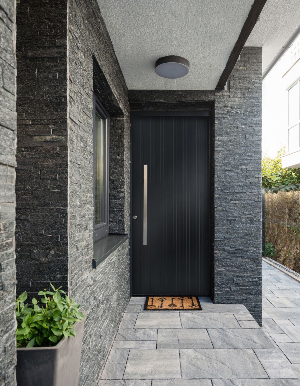 Sleek and contemporary, this aluminium door by Parkwood Doors features 
minimalist vertical grooves.