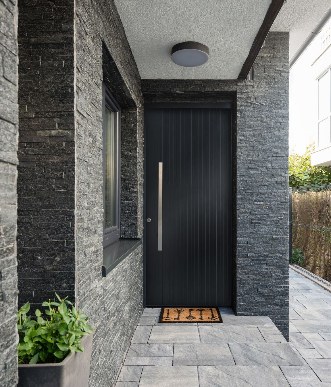 Sleek and contemporary, this aluminium door by Parkwood Doors features 
minimalist vertical grooves.