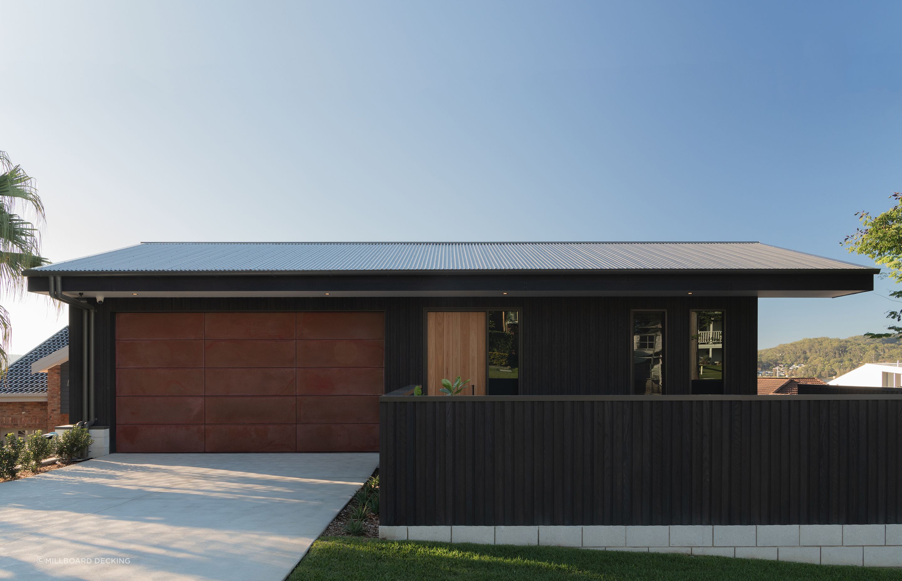 Millboard's Envello cladding in Burnt Cedar.