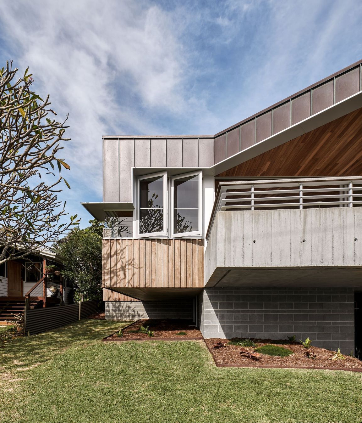 The hood on this beach house runs the length of this home for both practical and aesthetic purposes.