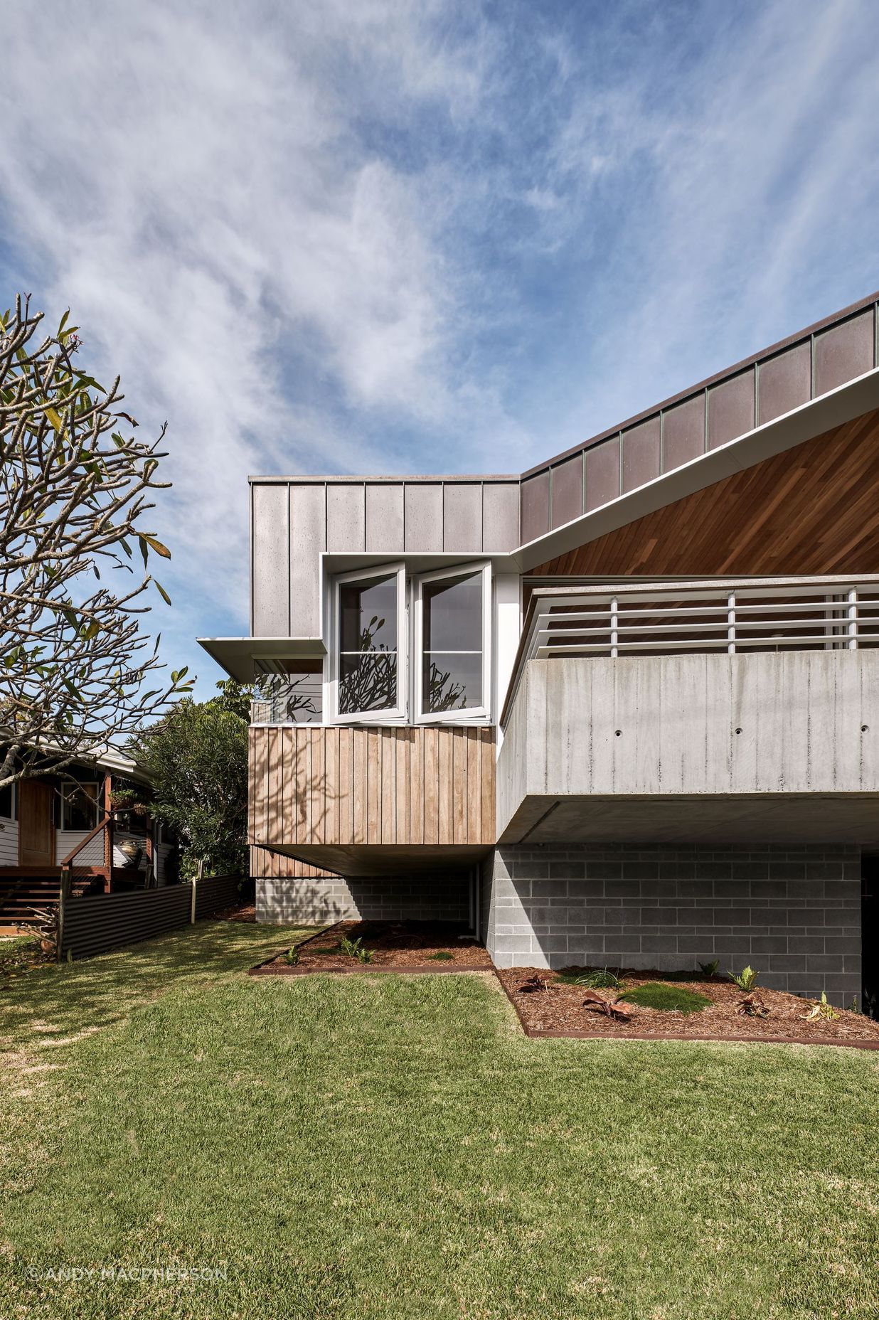 The hood on this beach house runs the length of this home for both practical and aesthetic purposes.