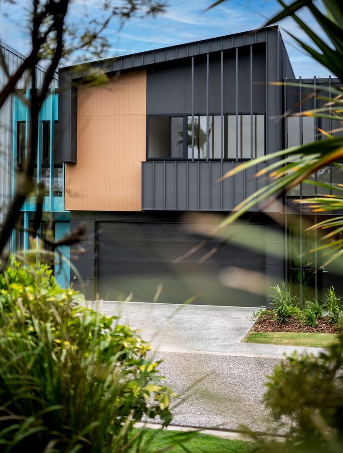 Bold black garage doors add depth and a modern touch.