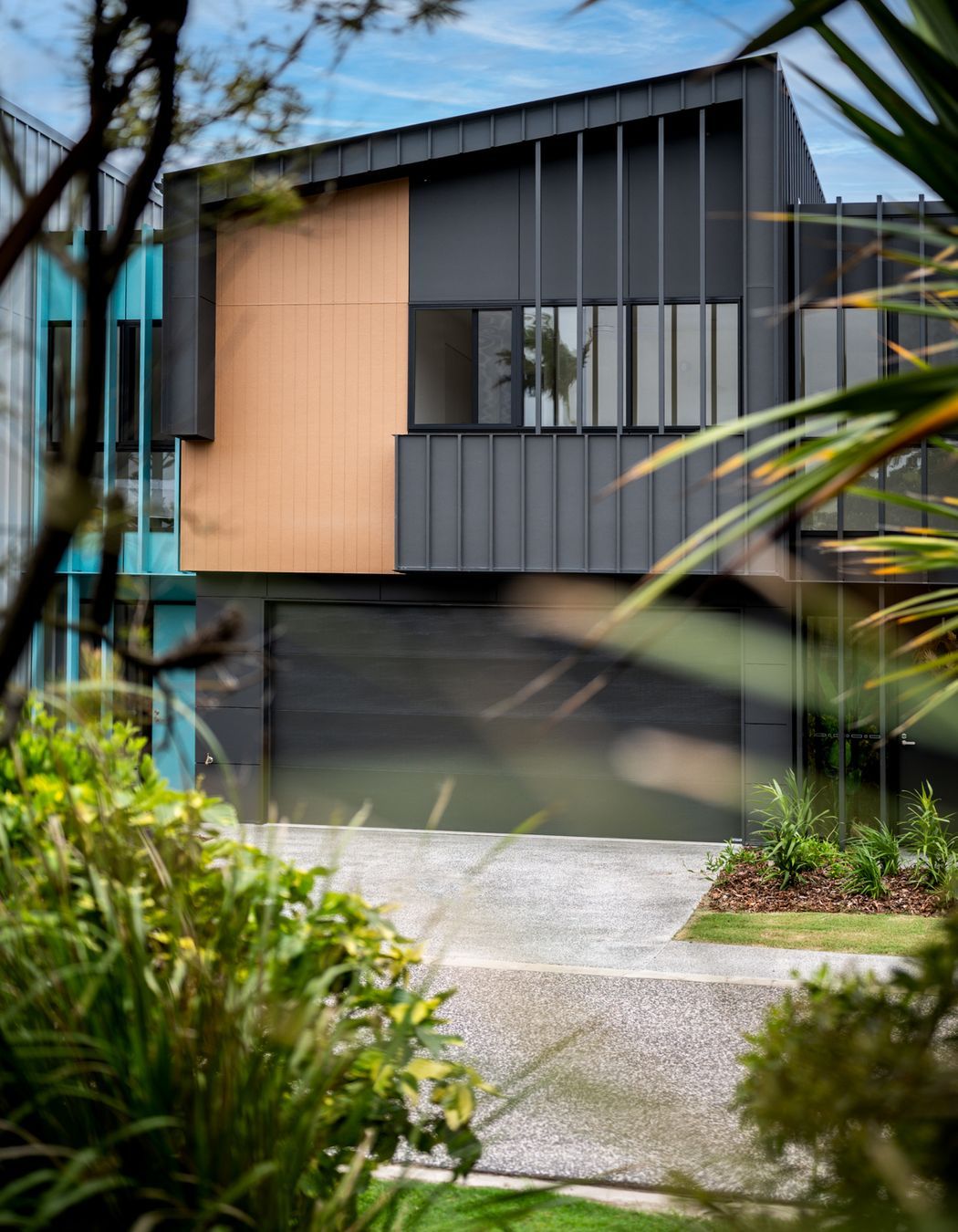 Bold black garage doors add depth and a modern touch.