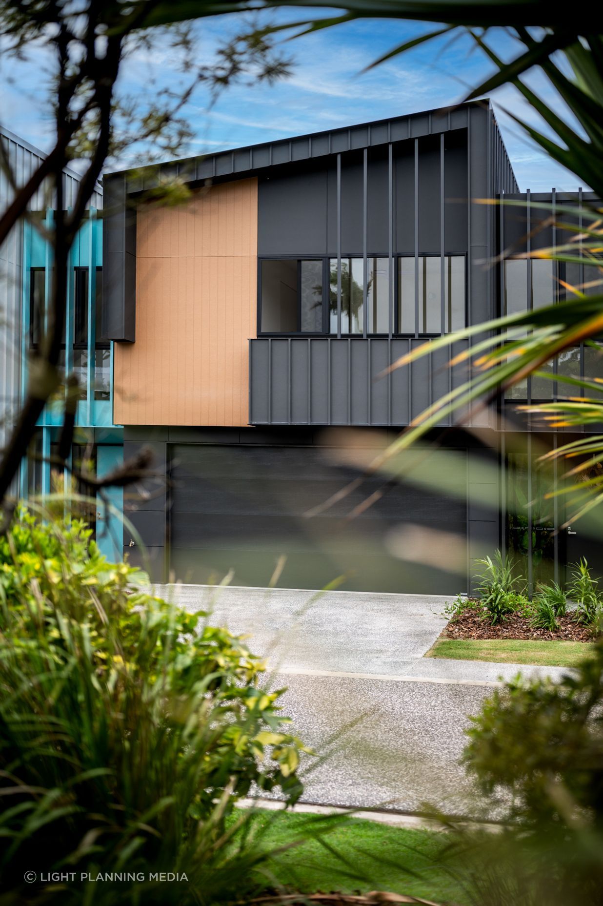Bold black garage doors add depth and a modern touch.