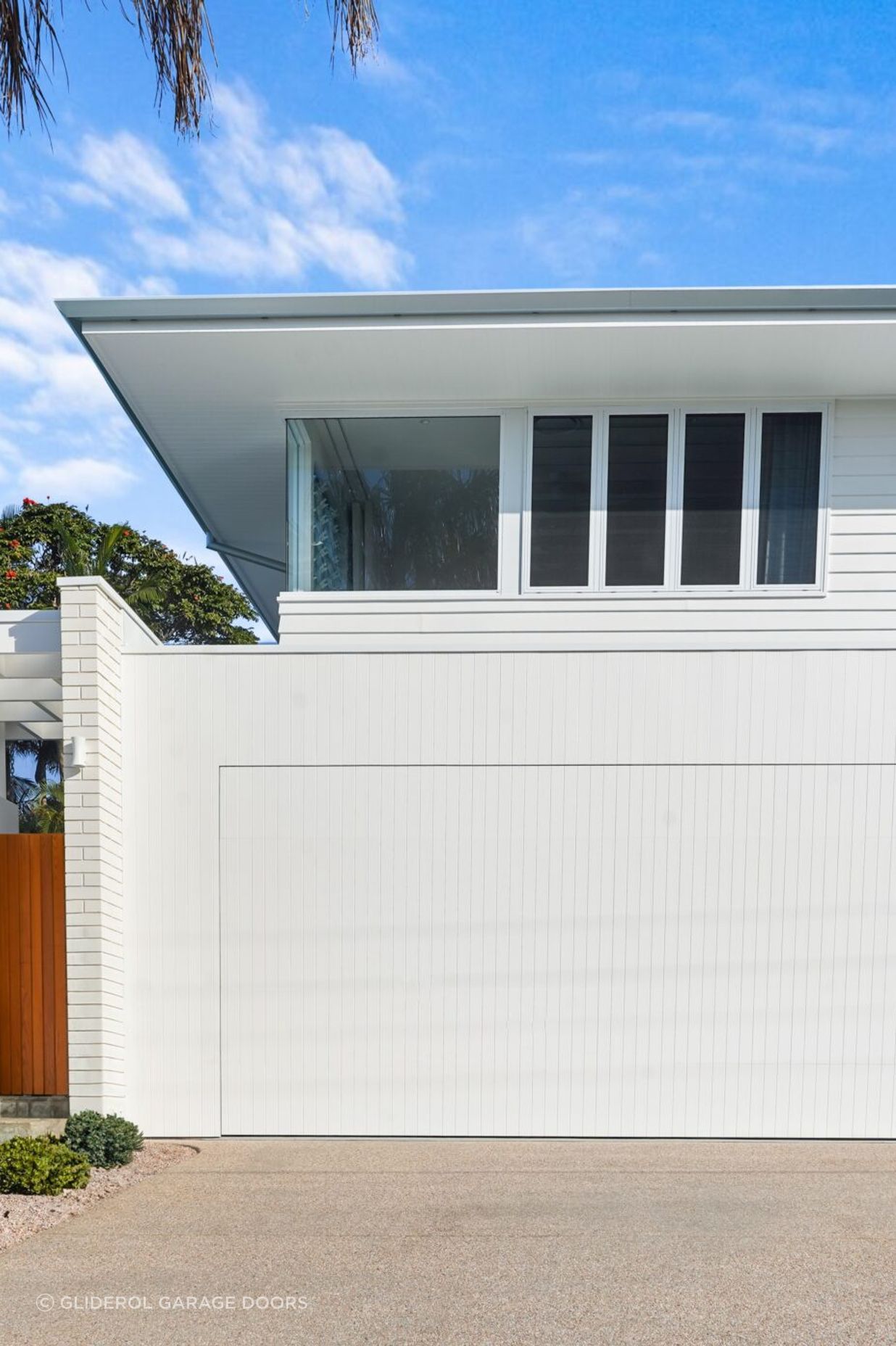 A natural timber garage door can be painted white to blend in with the front façade.