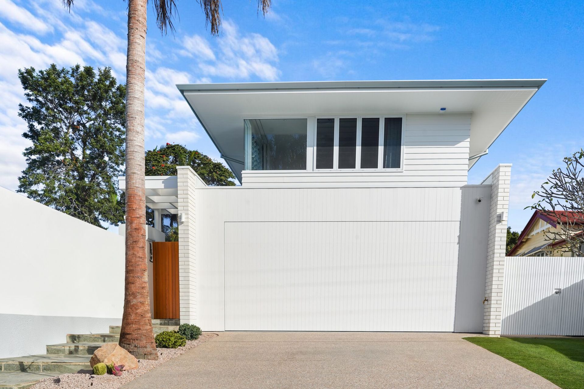 A natural timber garage door can be painted white to blend in with the front façade.