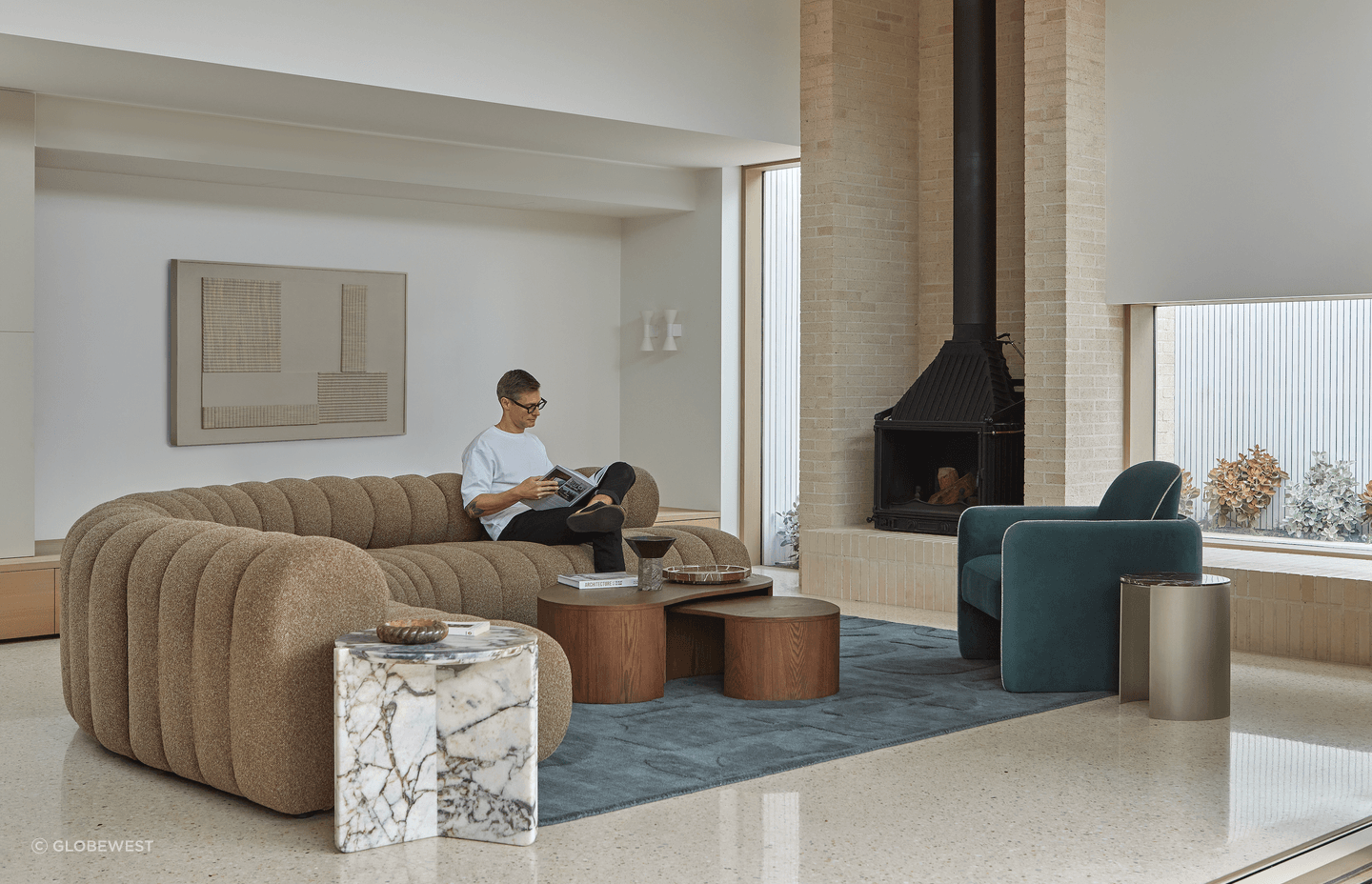 The collection's modular sofa designs offer flexibility and flow within comforting silhouettes. Layering is introduced with rugs and decor, with artwork adding interest to vertical spaces.