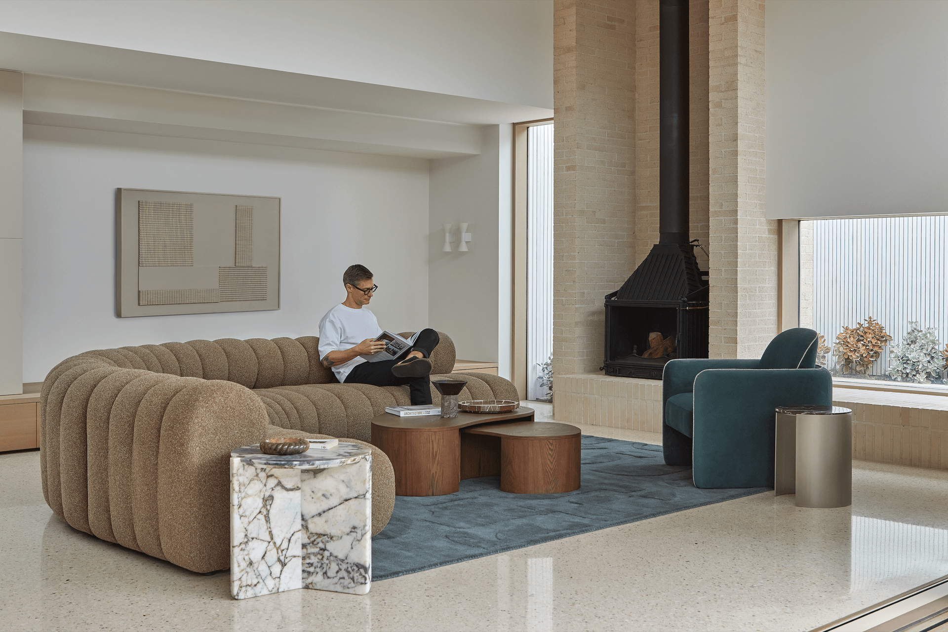 The collection's modular sofa designs offer flexibility and flow within comforting silhouettes. Layering is introduced with rugs and decor, with artwork adding interest to vertical spaces.