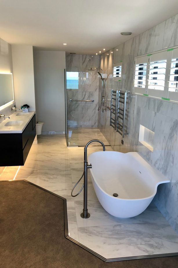 A Door Channel protects water leakage in this open-plan bathroom from going into the carpet.