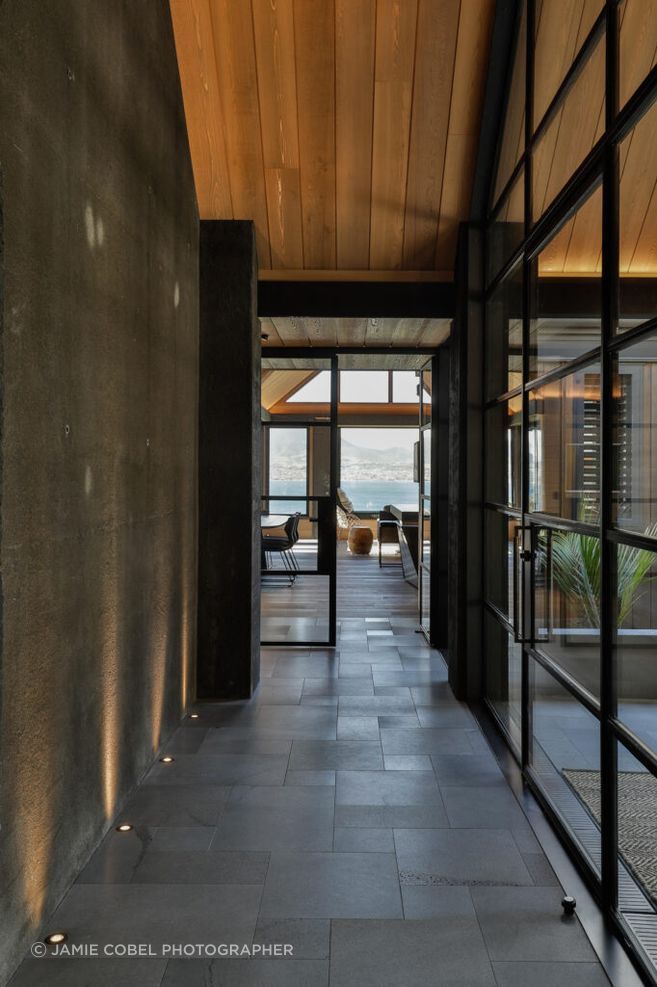 Bluestone paving with an antique tile finish creates an aged look for Taupō House.