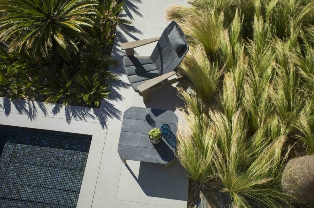 The Copenhague Adirondack Outdoor Chair by Les Jardins is designed for comfort and relaxation.