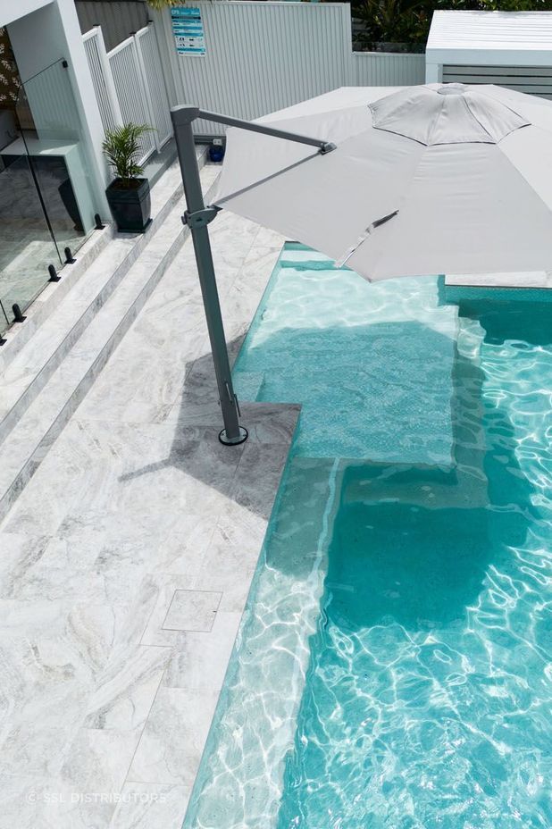 Platinum travertine complements a sleek, modern aesthetic.