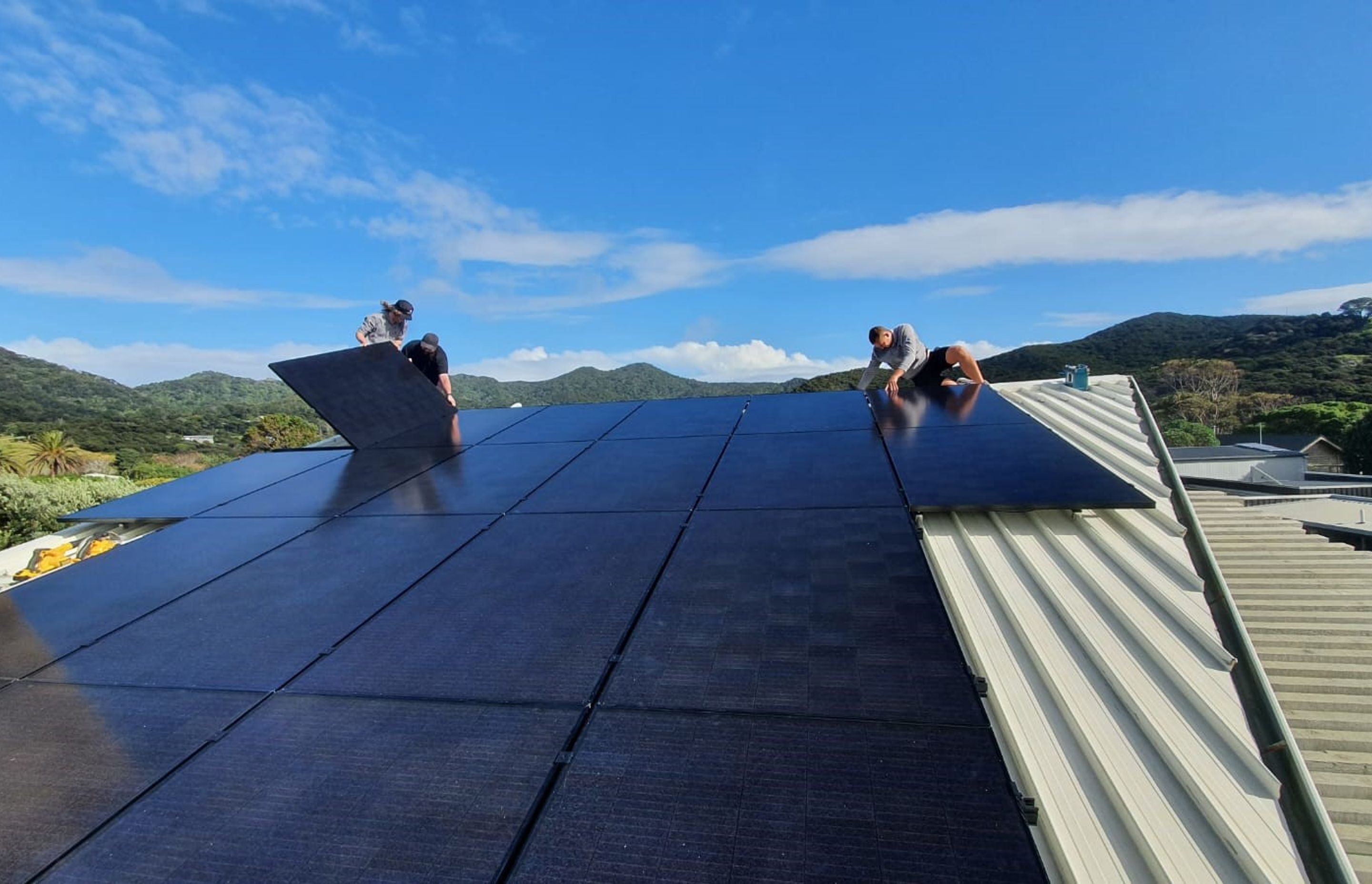 The team at Solarcraft installing roof panels.