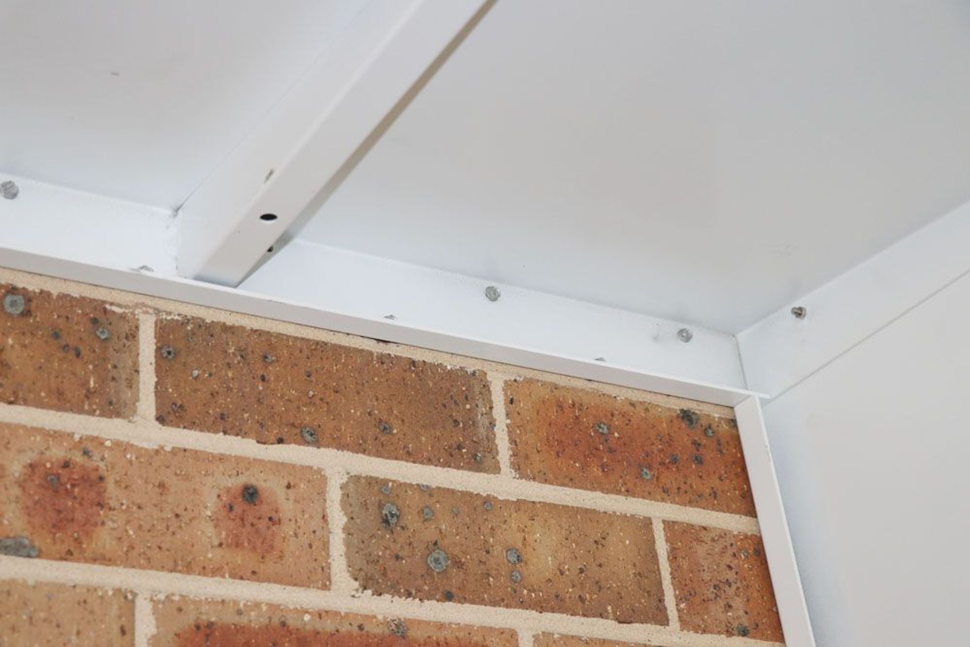 Trendline shroud affixed to a brick surface.