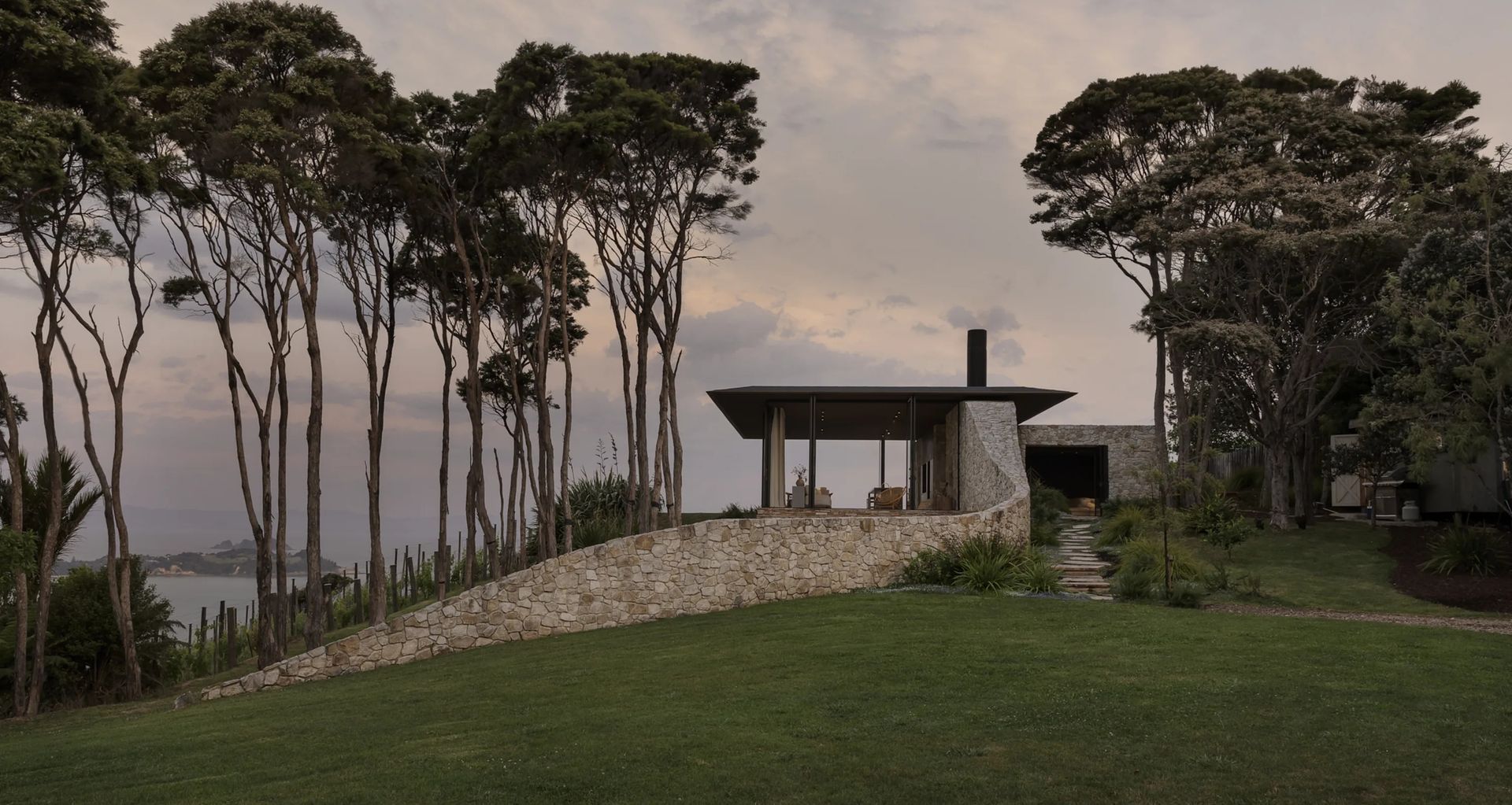 Aria limestone by The Natural Stone Co. defines this Waiheke Island home by Cheshire Architects, bringing weight, texture and a quiet connection to the surrounding coastal landscape. Photo Credit: Sam Hartnett
