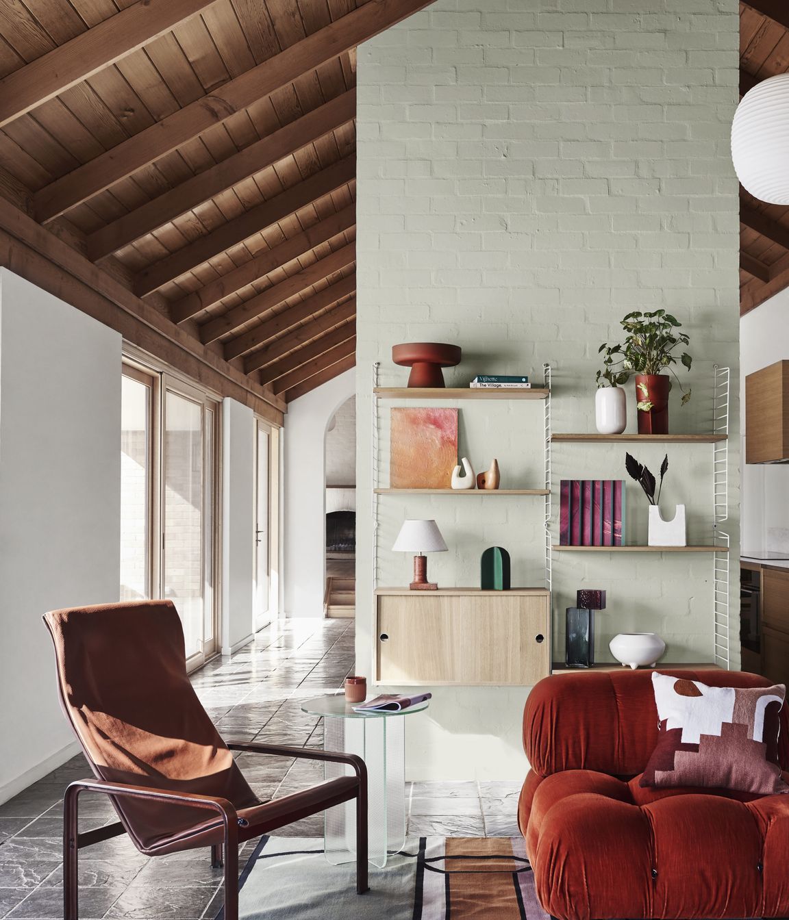 DULUX SUMMER FORECAST 2021. STYLIST: BREE LEECH. PHOTOGRAPHER: LISA COHEN. COLOURS: DULUX WOODS CREEK AND MT ASPIRING HALF. SUPPLIERS: VINTAGE CHAIR, GLASS VASE, ARTWORK (LEFT) BY RIA GREEN AND ARTWORK (RIGHT) BY TAJ ALEXANDER – MODERN TIMES; RUG – FENTON