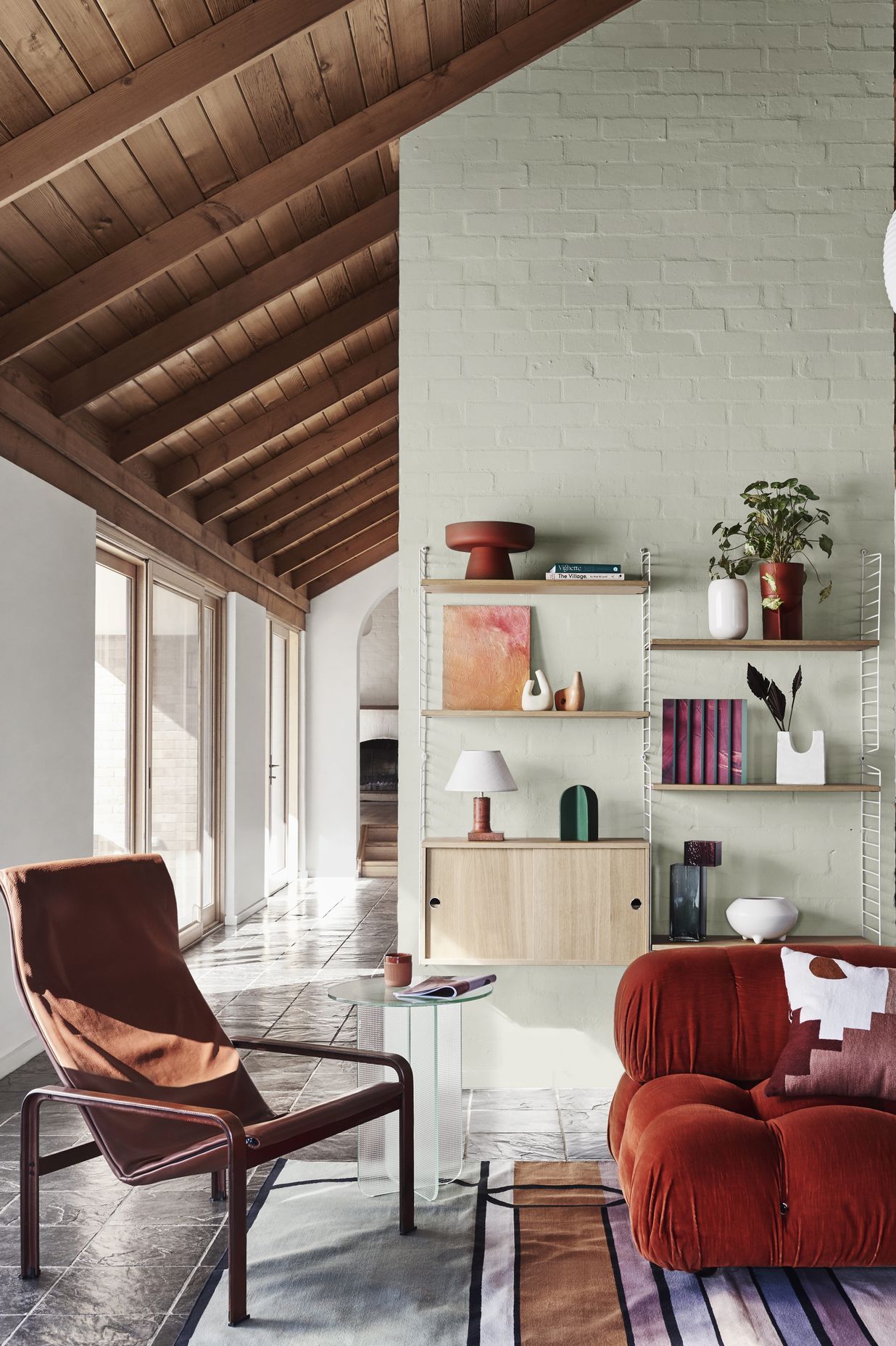 DULUX SUMMER FORECAST 2021. STYLIST: BREE LEECH. PHOTOGRAPHER: LISA COHEN. COLOURS: DULUX WOODS CREEK AND MT ASPIRING HALF. SUPPLIERS: VINTAGE CHAIR, GLASS VASE, ARTWORK (LEFT) BY RIA GREEN AND ARTWORK (RIGHT) BY TAJ ALEXANDER – MODERN TIMES; RUG – FENTON