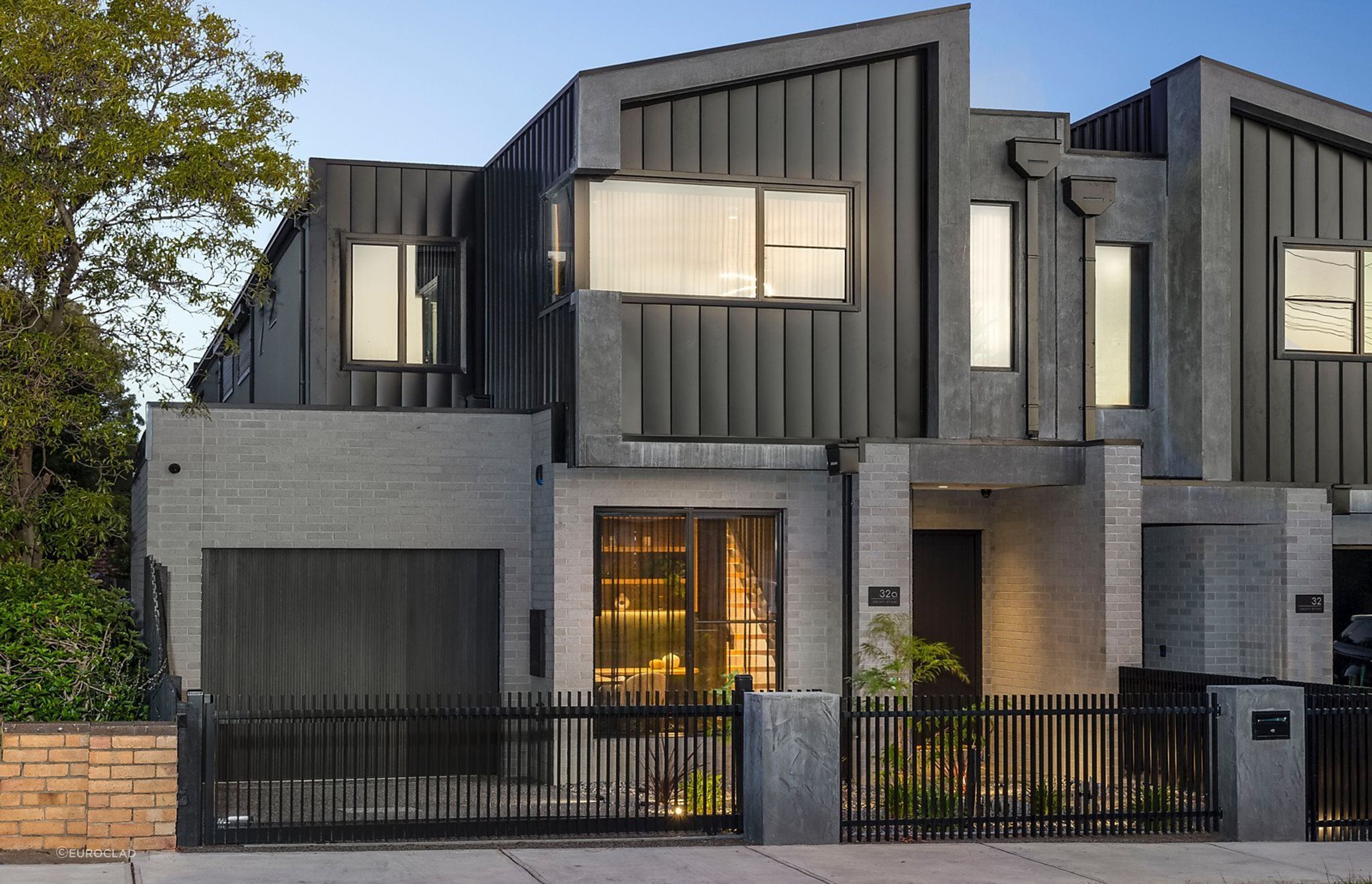 Singe lock cladding provides this townhouse with a clean, sleek finish. Featured product: Standing Seam Cladding.