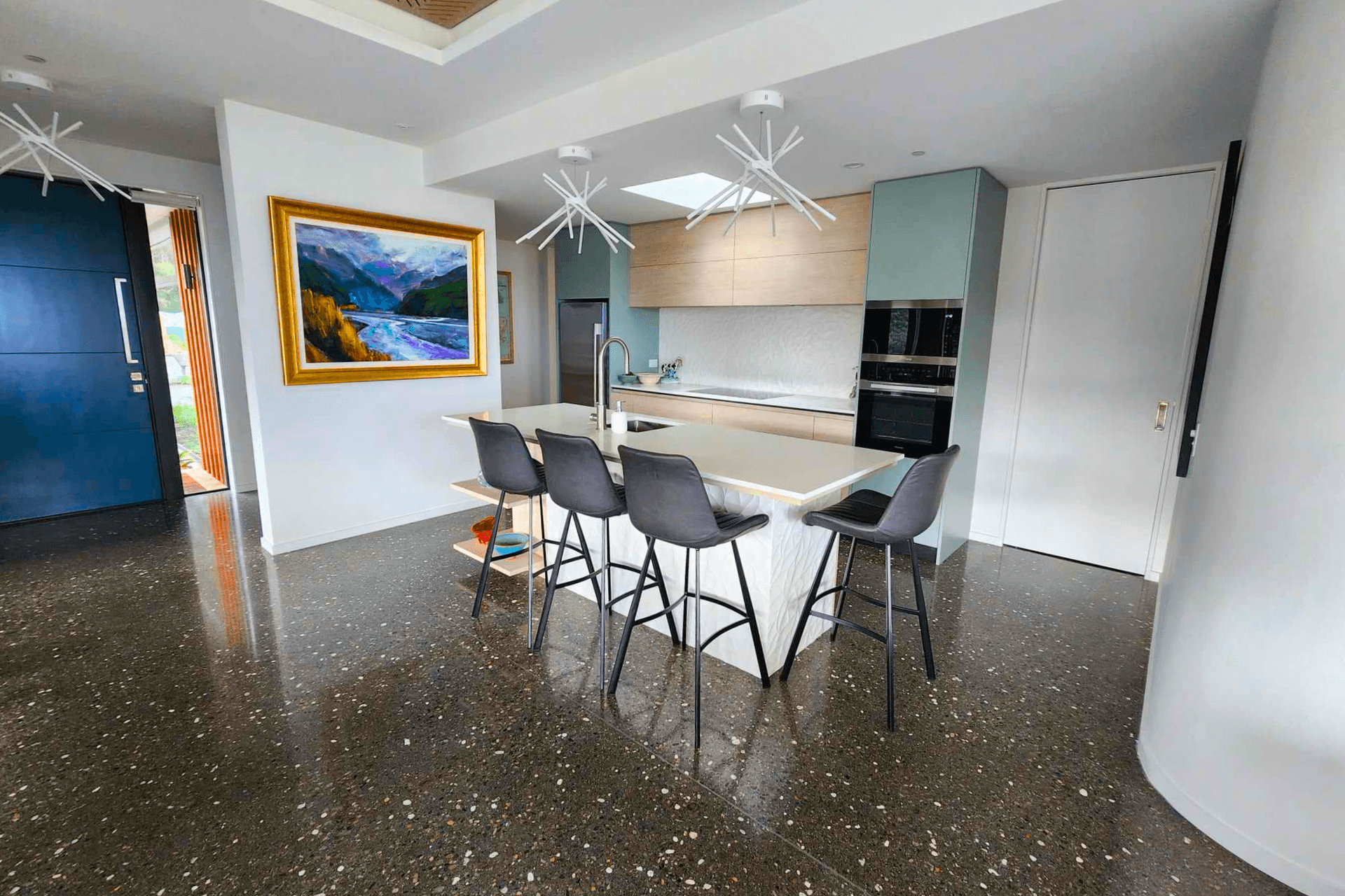 Polished concrete floors are a great way to bring a unique blend of style and functionality to the interior of your home, as featured in the Skylark Rise project
