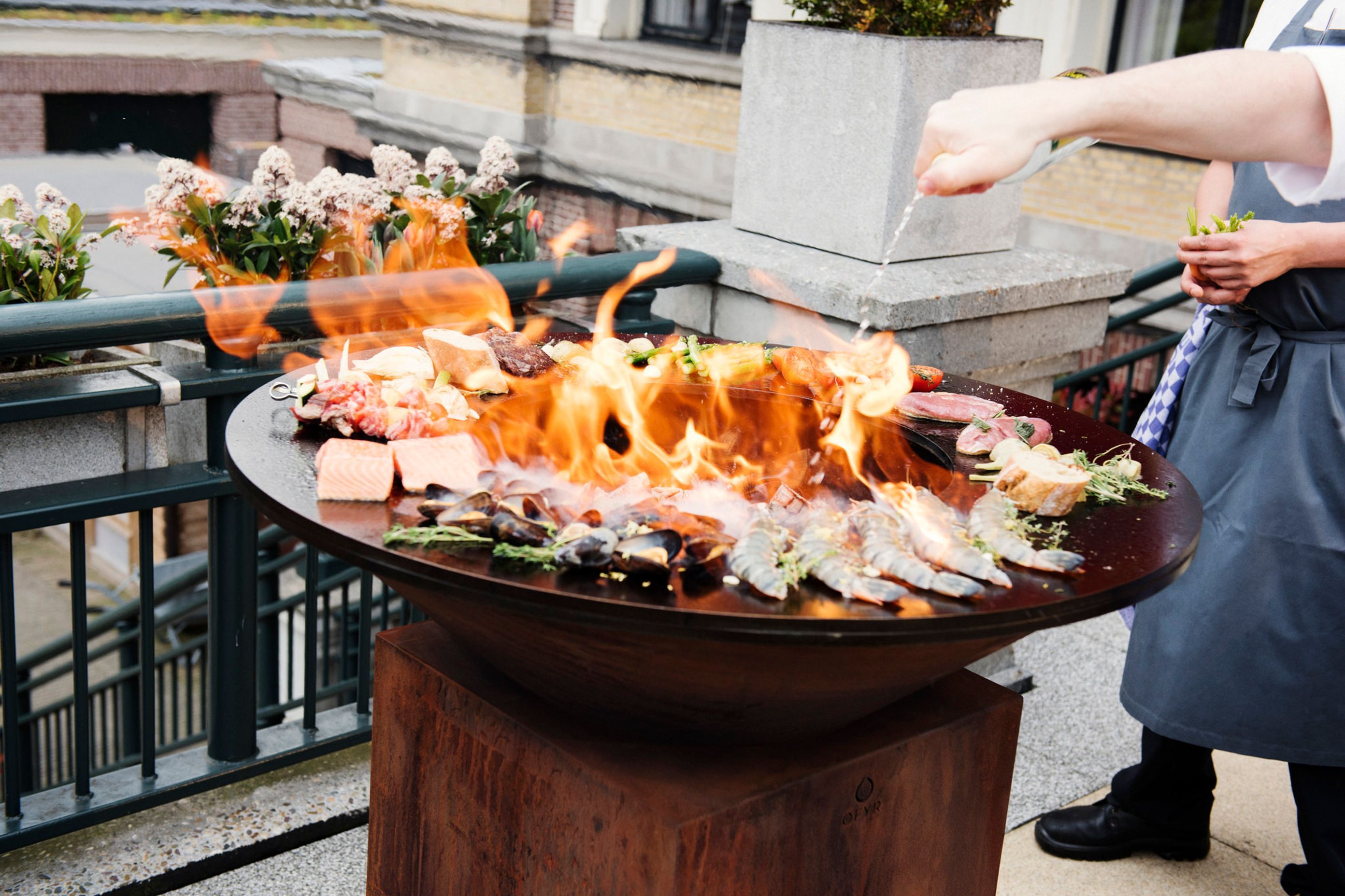 A fire pit with a hotplate or grill is a real showstopper, as you can see with the 100/100 by OFYR Outdoor Fire and Grill.