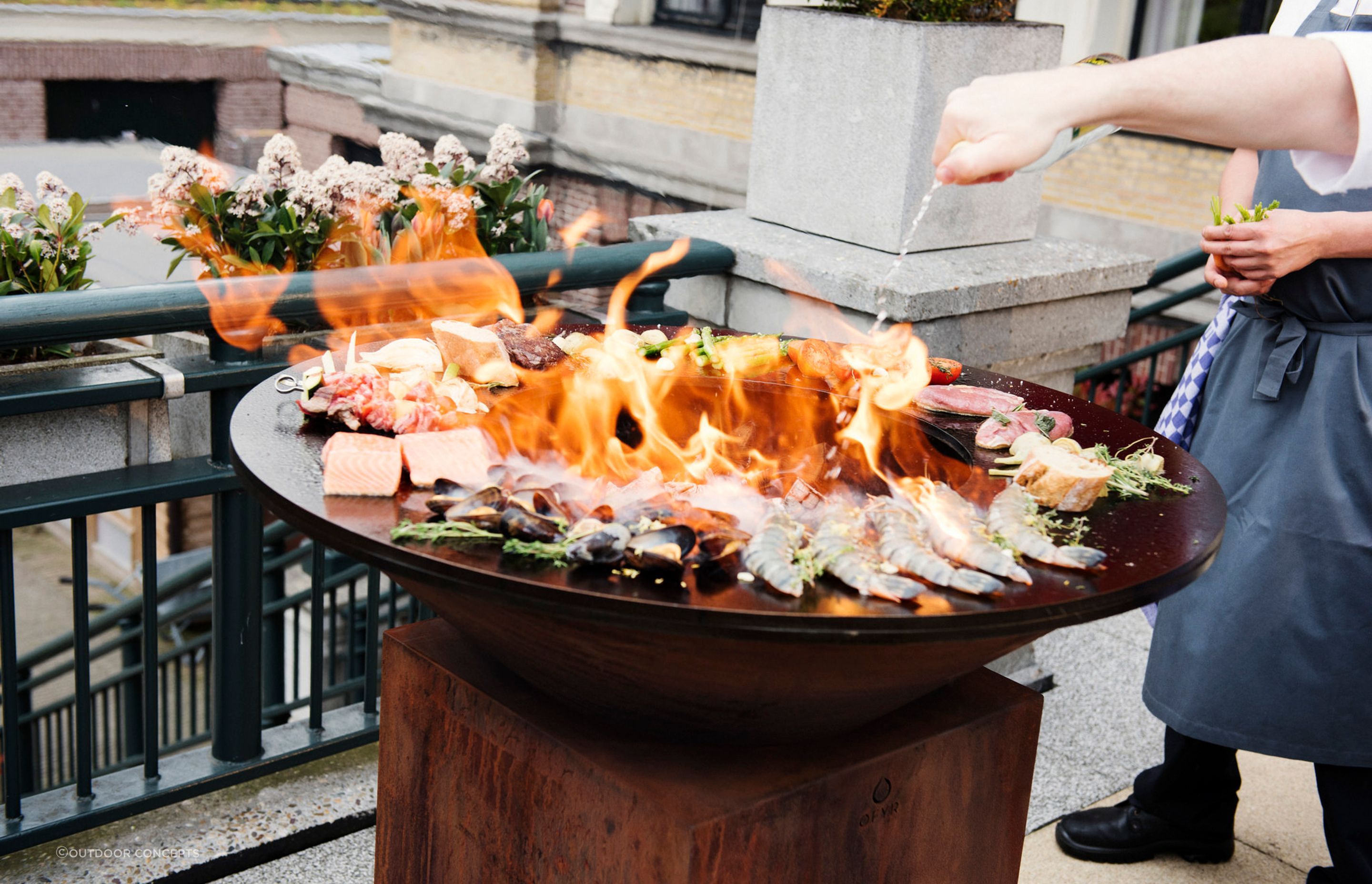 A fire pit with a hotplate or grill is a real showstopper, as you can see with the 100/100 by OFYR Outdoor Fire and Grill.