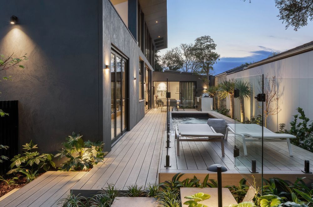 Incorporating greenery into your deck design, seen here in this deck made from CasaDeck by Outdure, will put you in one with nature.
