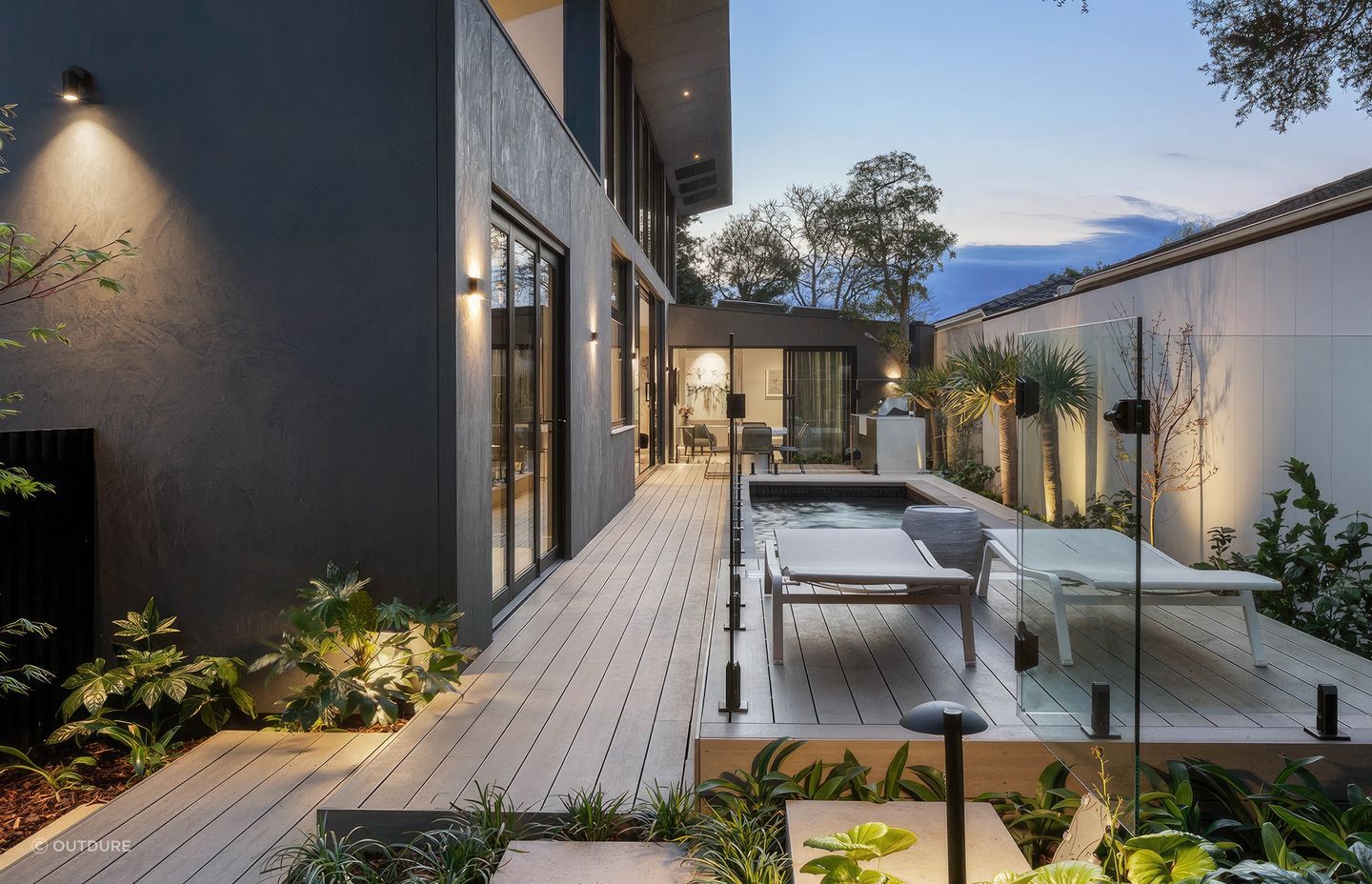 Incorporating greenery into your deck design, seen here in this deck made from CasaDeck by Outdure, will put you in one with nature.