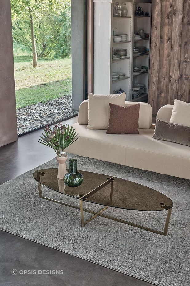 It's easy to compliment an oval coffee table with a vase and a stylish rug.