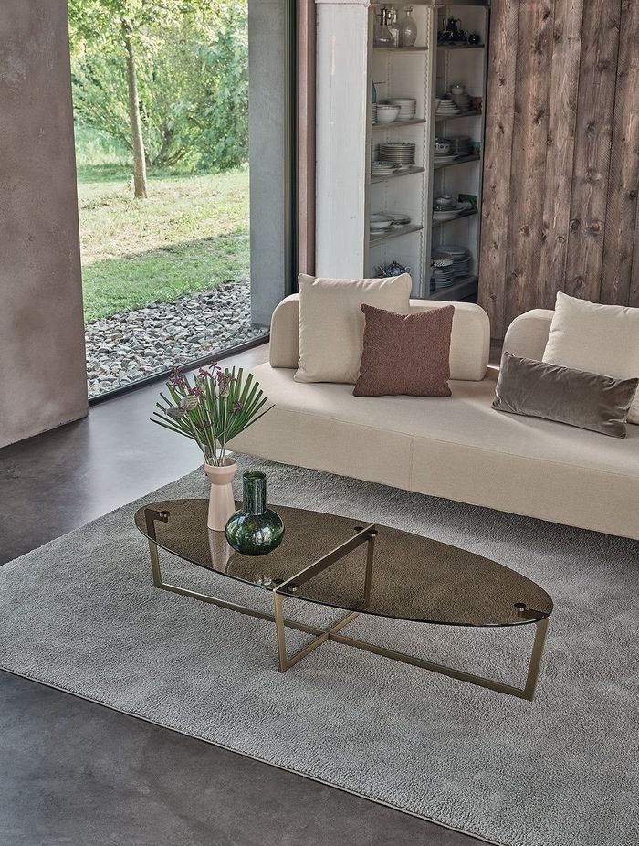 It's easy to compliment an oval coffee table with a vase and a stylish rug.
