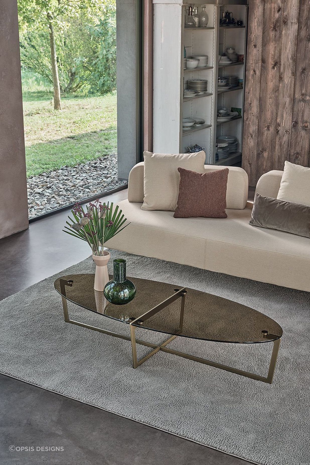 It's easy to compliment an oval coffee table with a vase and a stylish rug.