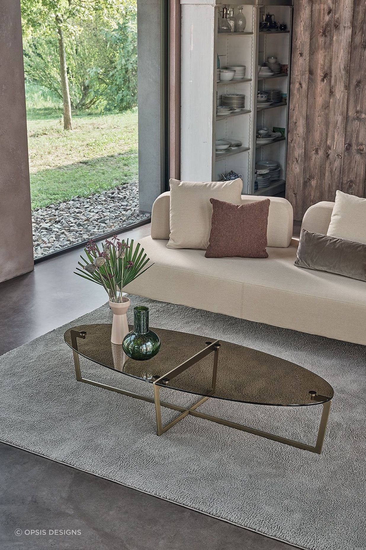 It's easy to compliment an oval coffee table with a vase and a stylish rug.