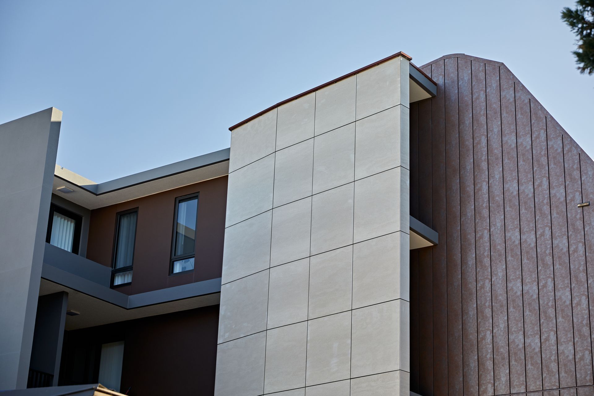 These fibre cement façade boards contrast well with the other materials used on the exterior of this building. Featured product: Genesis - Fibre Cement Cladding Boards.