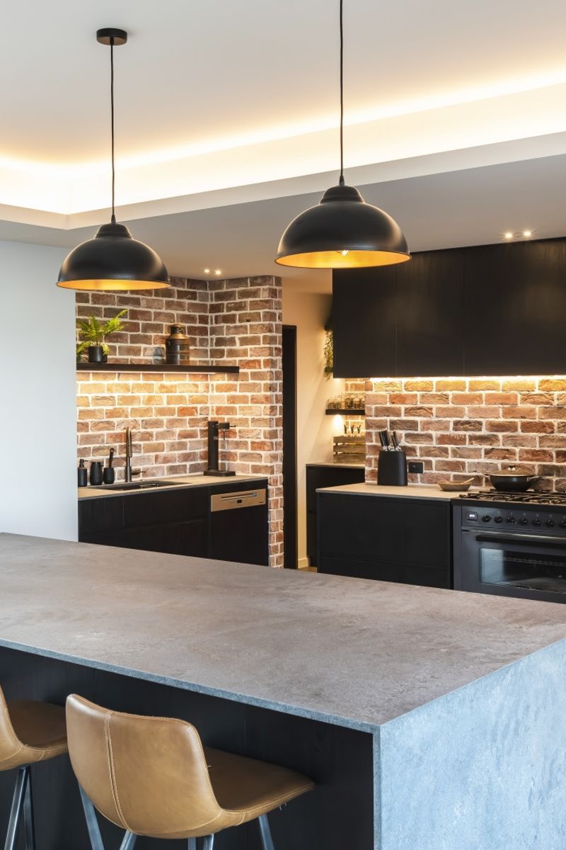 Recessed lighting highlights interesting design features in this modern kitchen built by DJ Hewitt Builders.
