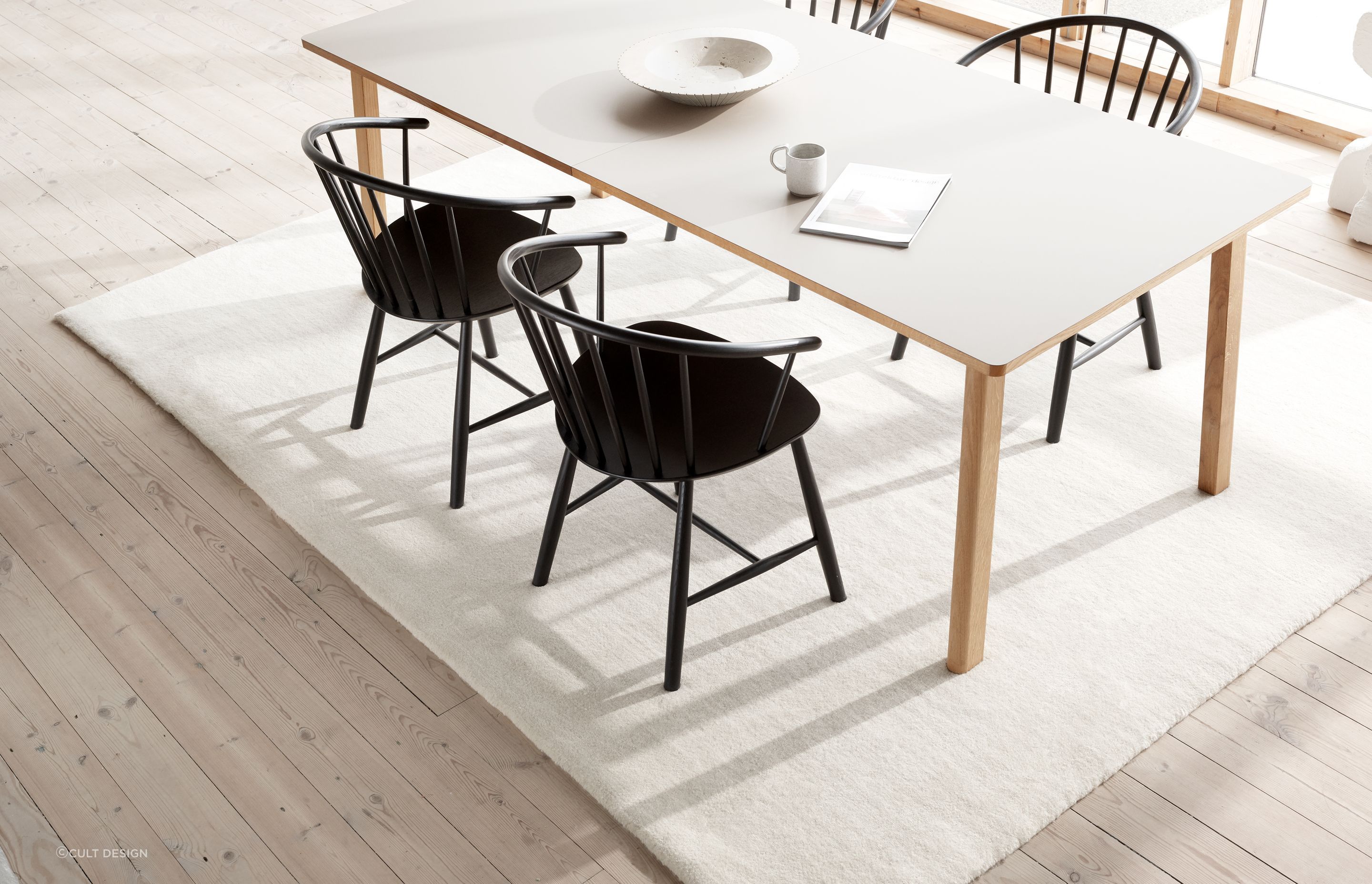 The right size rug won’t dominate a space, neither will it look awkward. Featured product: Ana Dining Table by Fredericia.