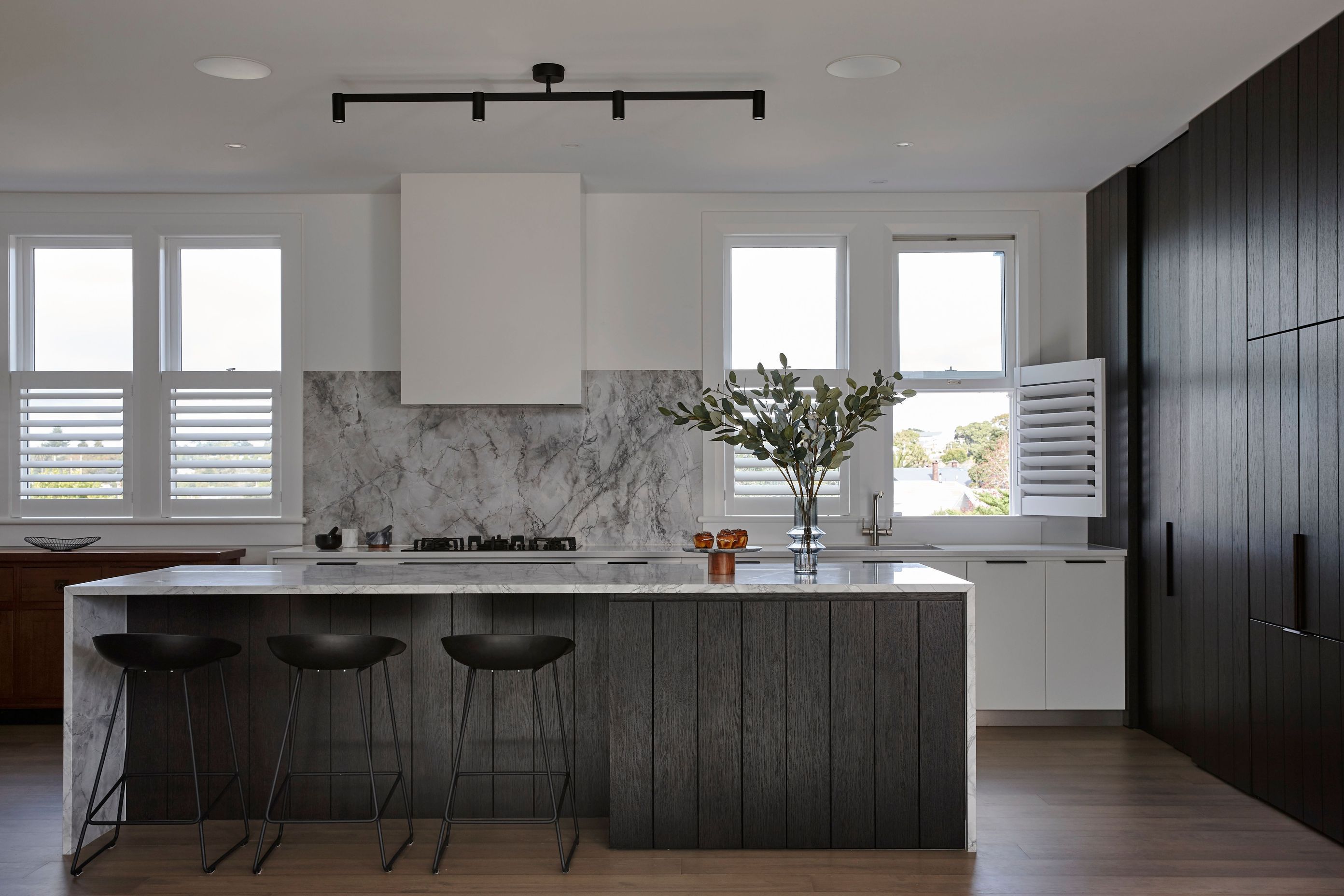 Internally, the Northcote Point bungalow is finished in a palette of natural stone, black steel detailing, bright white walls with rich stone and timber flooring to add warmth.