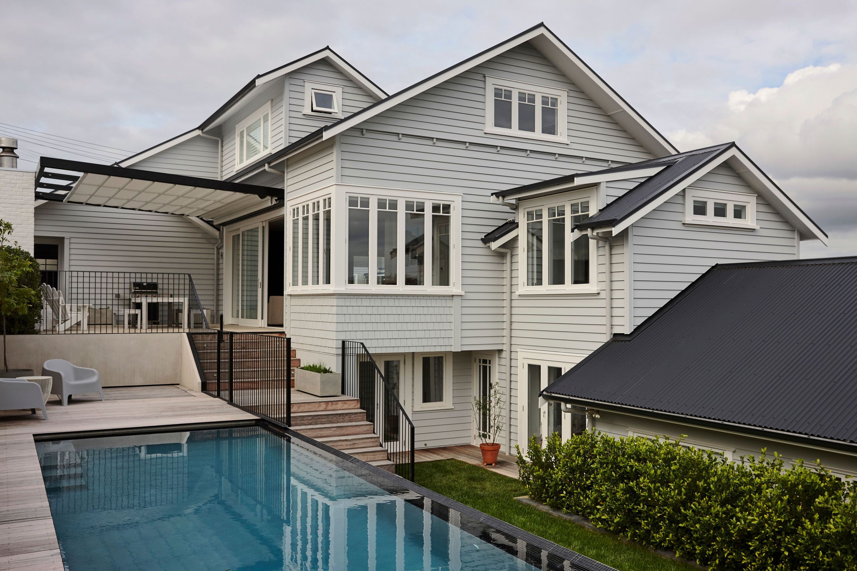 This bungalow renovation and extension in Northcote Point included a new top floor, extension and rebuild to existing addition of a garage, new outdoor living area and pool.
