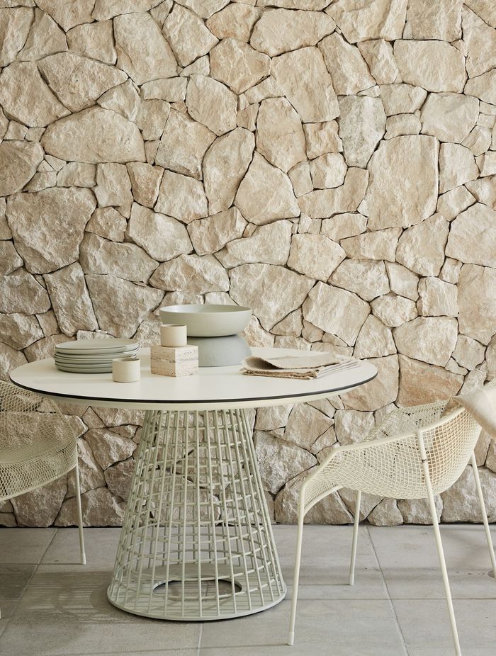 Savoca Freeform wall cladding and Calcetta Limestone flooring with the Mora Dining Table and Heaven Dining Armchairs.