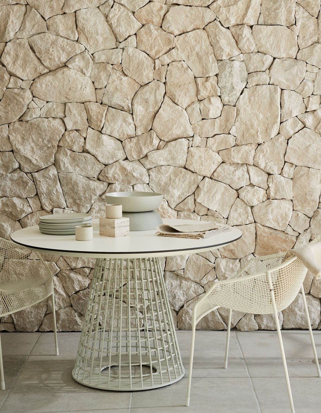 Savoca Freeform wall cladding and Calcetta Limestone flooring with the Mora Dining Table and Heaven Dining Armchairs.