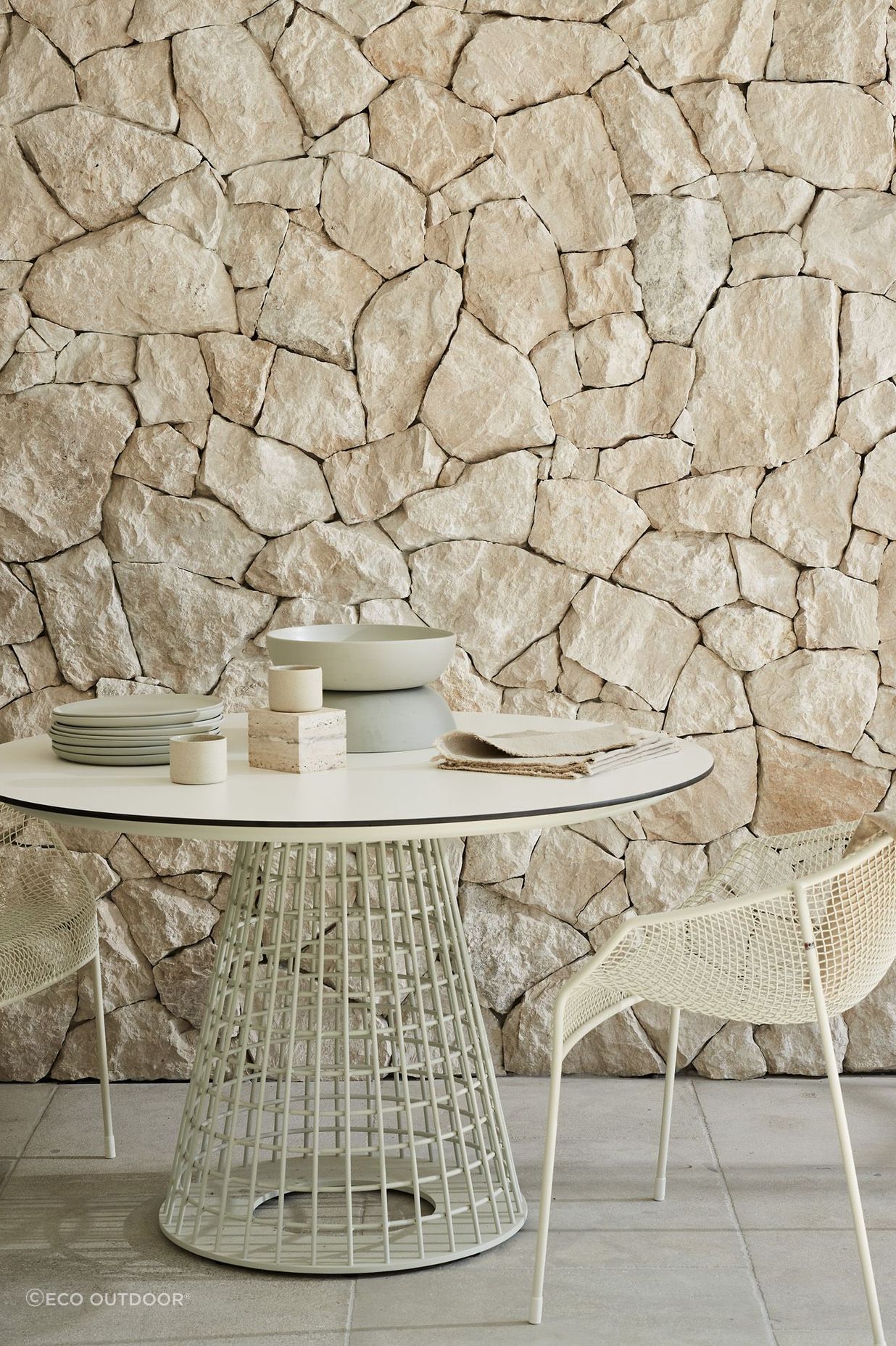 Savoca Freeform wall cladding and Calcetta Limestone flooring with the Mora Dining Table and Heaven Dining Armchairs.